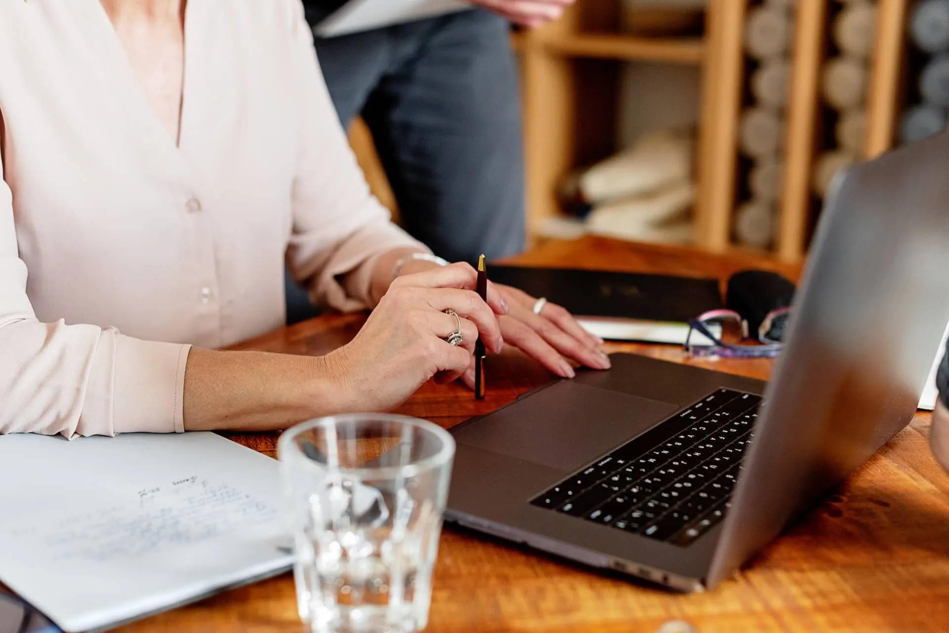 A woman at her desk with a laptop doing her work.