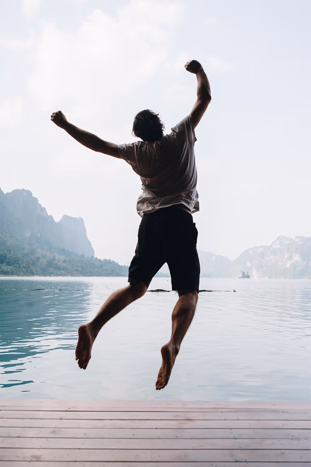 A man jumping in the air celebrating a goal.
